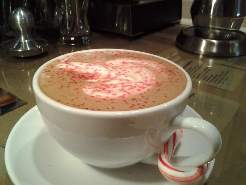 A festive peppermint mocha topped with whipped cream and crushed candy canes